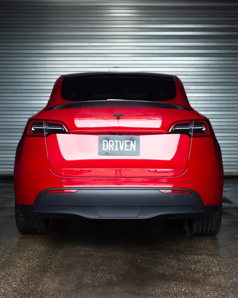 Red Tesla Model Y rear with DRIVEN plate