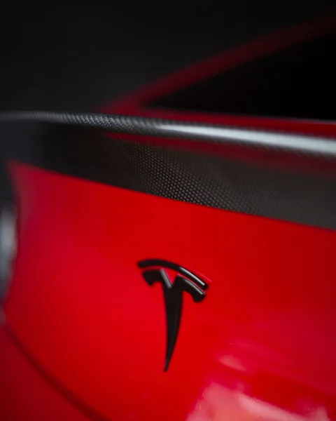 Tesla logo detail on red Model Y